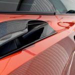 Orange sports car with carbon fiber body panels